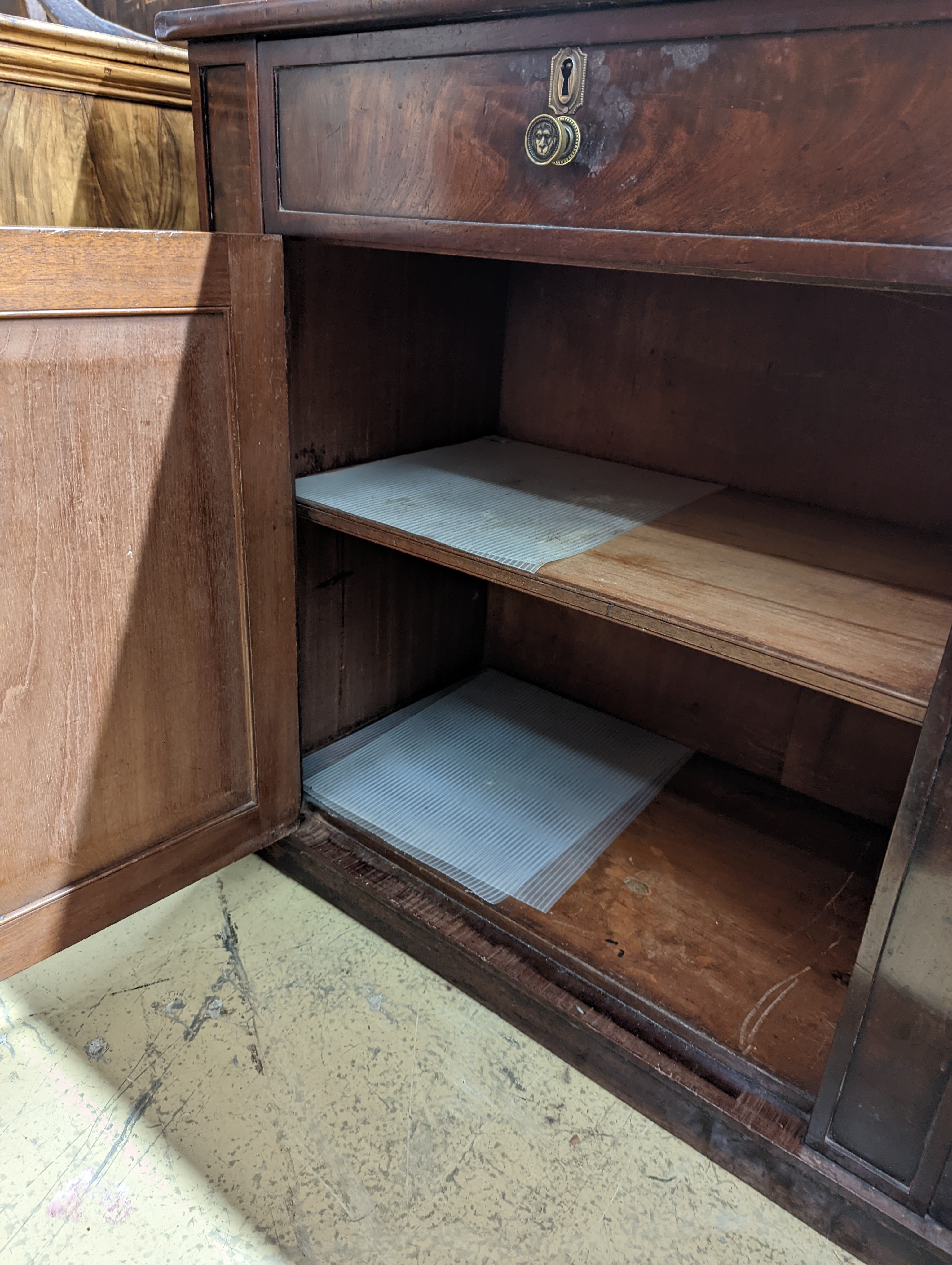 A Regency mahogany low cabinet fitted with two drawers, over a pair of cupboard doors and plinth base, width 138cm, depth 43cm, height 76cm